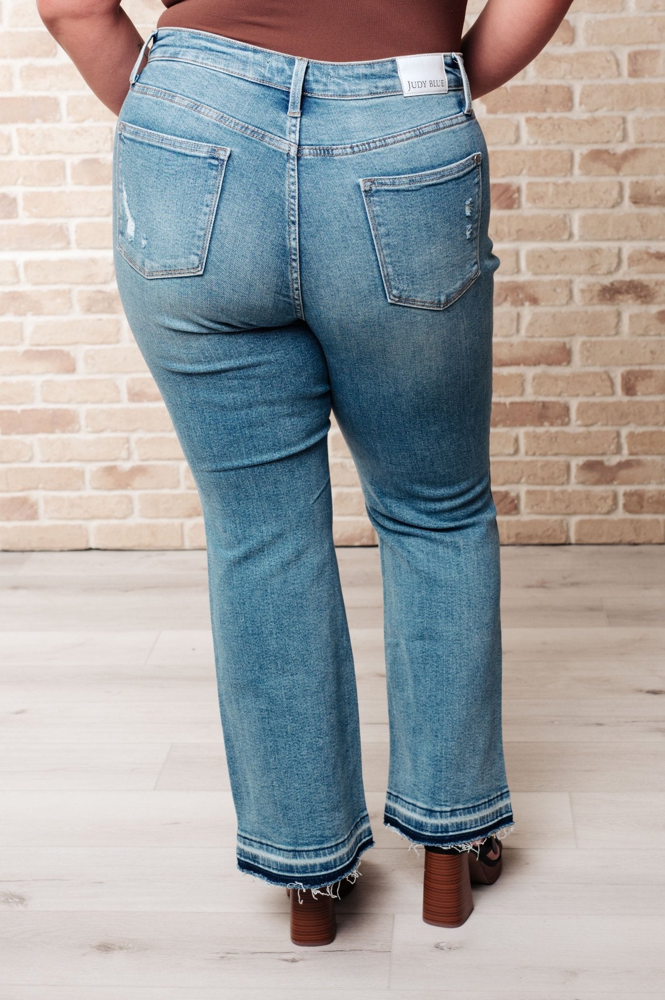 Isla Mid Rise Distressed Released Hem Bootcut Jeans - Loving God